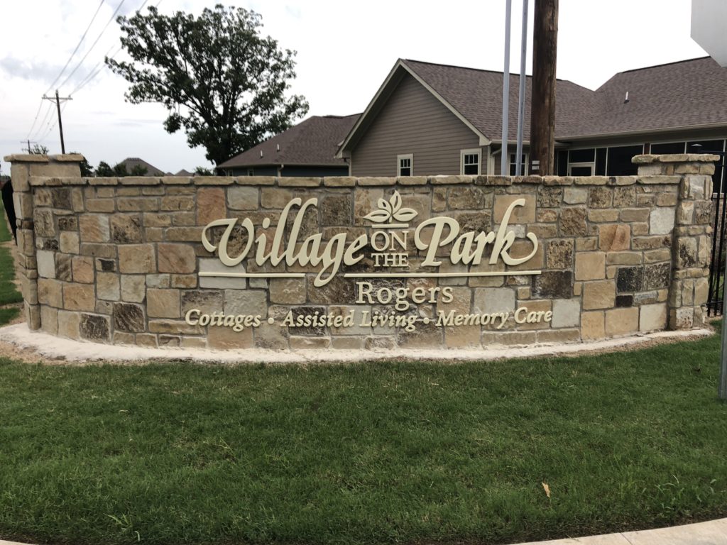 Village on the park Rogers Best Sign Group